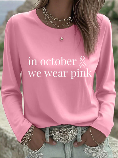 En octubre de las mujeres nos ponemos camiseta de manga larga rosada de la conciencia del cáncer de pecho